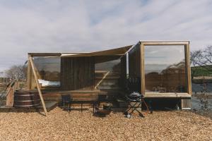 a tiny house with a tent and a table and chairs at Earthboat Saitama Kawajima in Kawagoe +26 photos