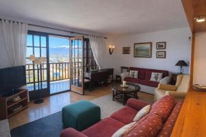 a living room with a couch and a piano at Llívia Sky Valley in Llivia
