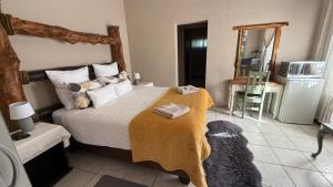 a bedroom with a bed and a dog laying on it at Marzel Guesthouse - Room 2 in Britstown