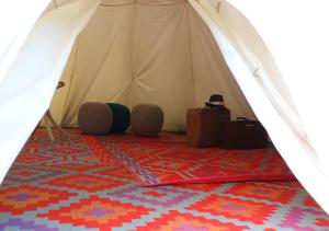 a white tent with a red carpet in front at Storchencamp Gästehaus Rust in Rust
