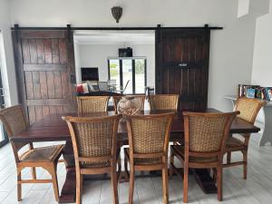 a dining room with a wooden table and chairs at The Gallery in Franskraalstrand