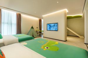 a hotel room with a bed and a tv at Panda Sleepy Hotel（Chengdu Panda Base) in Chengdu