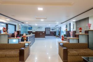 a lobby of a hospital with couches and flowers at La Comfort By shrpl in Gurgaon