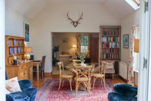 a living room with a table and chairs at Spacious cottage - walk to Crieff in Crieff