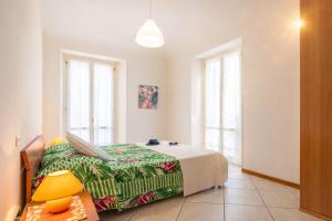 a bedroom with a bed and a table and windows at Piazza Verdi-Roseto Vacanza in Roseto degli Abruzzi