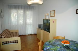 a living room with a table and a dining room at Residence Schubert in Lignano Sabbiadoro