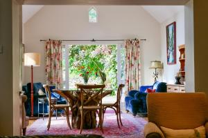 a living room with a table and chairs at Spacious cottage - walk to Crieff in Crieff