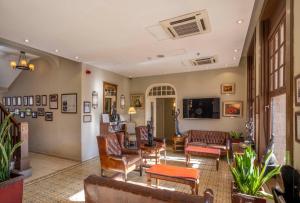 a living room with leather chairs and a couch at The Colony Hotel in Haifa