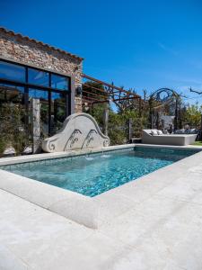 a swimming pool in front of a house at L'Intemporel in Saint-Cyr-sur-Mer