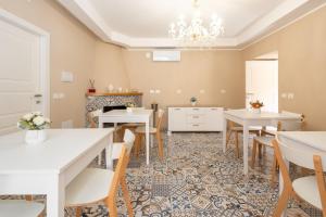 a dining room with tables and chairs and a chandelier at B&B Fonte Silente in Roccadaspide