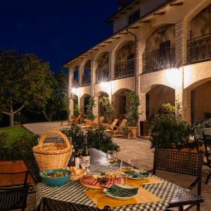 a table with plates of food on it in front of a building at Vitabella Toscana in Seggiano