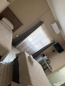 a bedroom with a bed and a large window at Marzel Guesthouse - Room 2 in Britstown