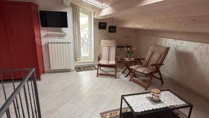 a living room with two chairs and a table at Iris Chioggia in Chioggia