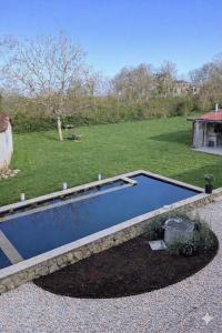 a swimming pool in the middle of a yard at Maison Saizy in Monceaux-le-Comte