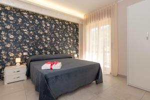 a bedroom with a bed with two towels on it at B&B Fonte Silente in Roccadaspide +12 photos