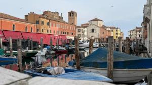 a group of boats docked in a harbor with buildings at Iris Chioggia in Chioggia