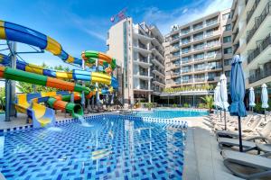 a pool with a water slide in a hotel at Best Western PLUS Premium Inn in Sunny Beach