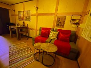 a living room with a couch and a table at Wildhütte Schinderhannes in Schwarzerden