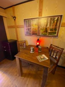 a wooden table and chairs in a room at Wildhütte Schinderhannes in Schwarzerden