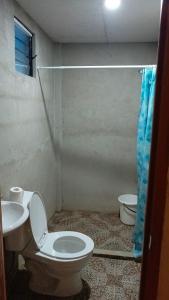 a bathroom with a toilet and a sink at Coastline Homestay in Burgos