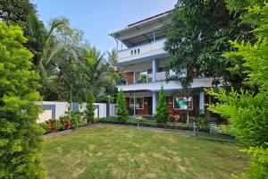 an exterior view of a house with a yard at Basil Leaf Resort in Varsoli