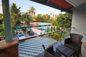 a balcony with chairs and a view of a pool at Basil Leaf Resort in Varsoli