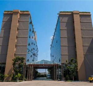 a tall building with a bridge over a road at Elegant Airport Hotel in Bangkok