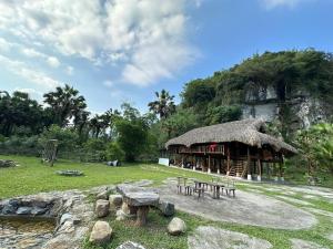 a hut with a table and benches in a field at Laben Ecolodge in Na Dong +13 photos