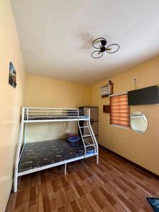 a room with a bunk bed and a ceiling at Amad's Rental Space Family Room in Bantayan Island
