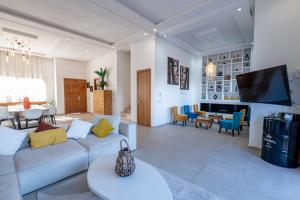 a living room with a couch and a dining room at Villa Palms de l'Atlas in Marrakesh