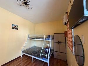 a bunk bed in a room with a ceiling at Amad's Rental Space Family Room in Bantayan Island