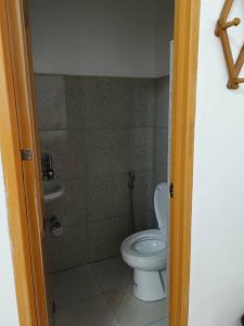 a small bathroom with a toilet and a sink at Amad's Rental Space Family Room in Bantayan Island