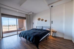 a bedroom with a bed and a large window at Villa Palms de l'Atlas in Marrakesh +54 photos