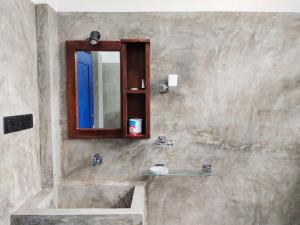 a bathroom with a sink and a mirror at Sundaze Villa in Goyambokka +76 photos