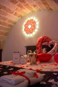 a room with a table with a candy cane and a light at Hesperia Suite - Jacuzzi & Garden in Corigliano dʼOtranto
