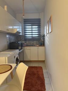 a small kitchen with a sink and a stove at Dimi's home in Komotini