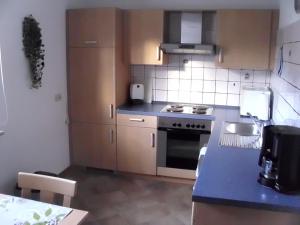 a small kitchen with a blue counter top at Ferienwohnung Kroeschell in Bad Sachsa
