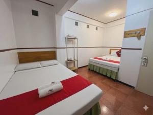 a room with two beds in a room at Axis Pension Hotel in Mactan