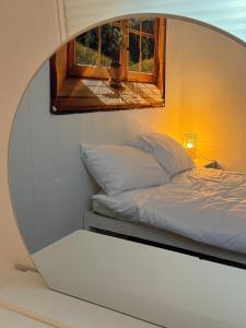a bed in a room with a mirror at YuYu stay in Seoul