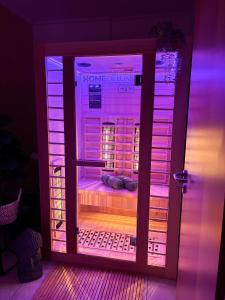 an open door with purple lights in a room at GRO-Ferienhaus in WÃ¶lpinghausen