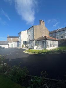 a building with a lot of windows in a parking lot at Ashmore House Cashel in Cashel