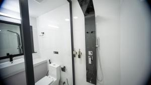a bathroom with a toilet and a sink and a mirror at Alyraa Sunset Mathiveri - Free Picnic Island Trip Included in Mathiveri +21 photos