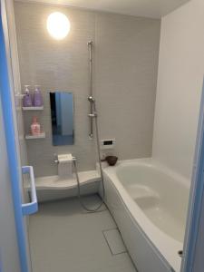 a bathroom with a shower and a tub and a sink at yuanquanHOTEL in Osaka +26 photos