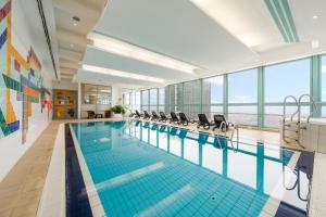 a large swimming pool with chairs in a building at Panorama by Verdi Hotels in Prague