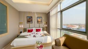 a bedroom with a bed and a large window at Elegant Airport Hotel in Bangkok +40 photos