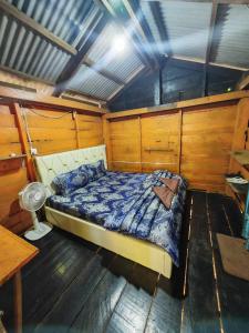 a bedroom of a boat with a bed in it at Happy Elephant Bungalows in Senmonorom