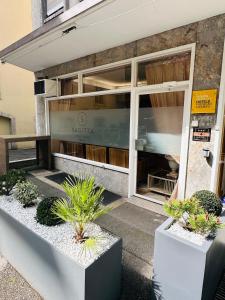 a store front with plants in front of it at Hotel Sagitta in Geneva