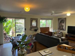 a living room with a couch and a table at 225 on Myall in Tea Gardens