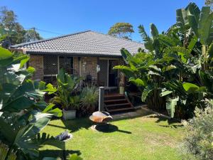 a house with green plants in front of it at 225 on Myall in Tea Gardens