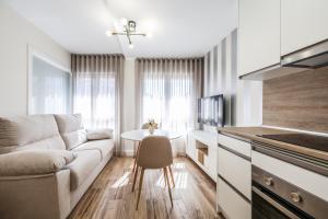 a living room with a couch and a table at Polán Living | New Apartment - B in Polán